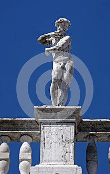 Statue at the top of National Library of St Mark`s Biblioteca Marciana, Venice, Italy photo