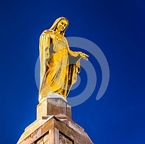 Statue on top of The National Shrine Grotto of Lourdes in Emmitsburg, Maryland. photo