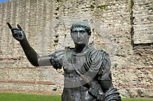 Statue of Trajan in front of a section of the Roman wall, Tower