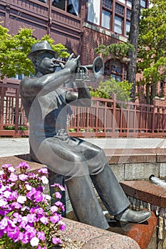 Statue of trumpet player in front of Weathercock House in historic area of Kitano district in Kobe, Japan