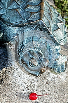 Statue of a turtle along a walk way photo
