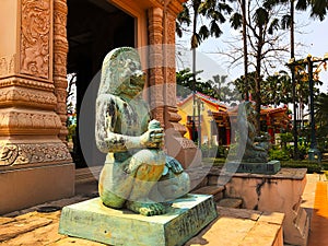 Statue of two lion head deities guarding in front of a city pillar shrine