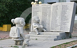 Statue of a two school kids and big book.