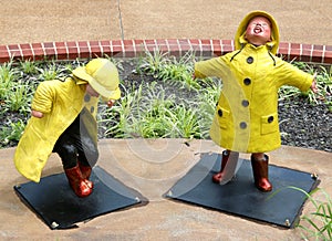 Statue of Two Young Children Splashing And Stomping In The Rain