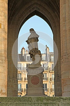 Statue under the gothic style bell tower of the Tour Saint-Jacques in Paris