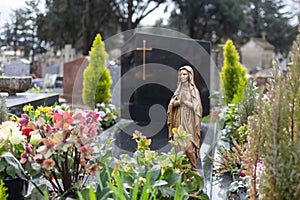 Statue Virgin Mary at cemetery, graveyard in daylight