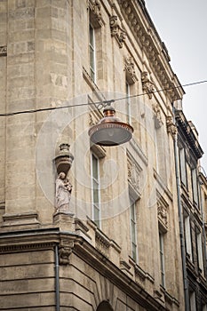 Statue of the Virgin Mary on the corner of a building in the Bordelaise streets