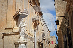 Statue of Virgin Mary with Jesus child on the corner of Carmelite Priory in Mdina. Malta