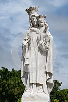 Statue of Virgin Mary with Son Jesus, Both with Crown, Marble Statue on Cemetery Cementerio Santa Ifigenia, Santiago de Cuba, Cuba photo