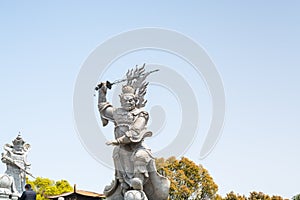 Statue of the Viruá¸haka Heavenly King in front of Golden statue of bodhisattva guanyin Mount Luojia, Zhoushan, Zhejiang, the