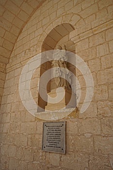 A statue in the wall opening of the Mellieha Parish Church. Mellieha, Malta