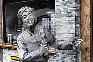 Statue welcoming tourists into restaurant along Kuanzhai Alleys,