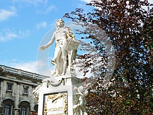 Statue of Wolfgang Amadeus Mozart against sunny blue sky, Burggarten Park in Vienna