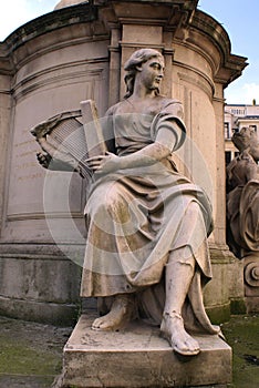 Statue of a woman musician playing a harp