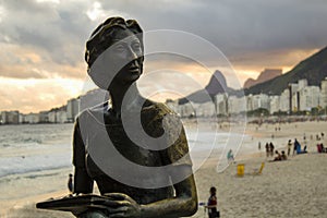 Statue of the writer Clarice Lispector with her dog `Ulisses` in the `Fishermen`s Way` with the sea in the background on the beach