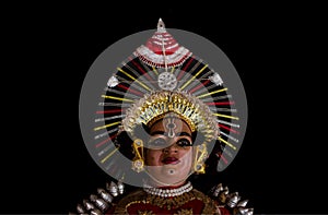 Statue of Yakshagana dace artist  on black background. Yakshagana is a traditional folk dance of India photo