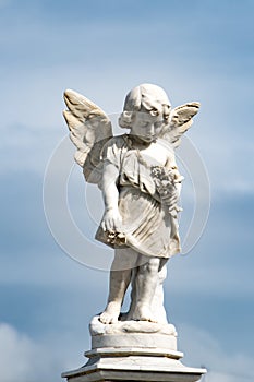 Angel, little girl with wings and flowers, marble statue on Cemetery Cementerio Santa Ifigenia, Santiago de Cuba, Cuba photo