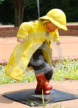 Statue of Young Child Splashing And Stomping In The Rain