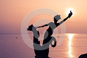 Statue of a Young Girl Holding a Shell and Riding a Seahorse Hippocampus in front of Lake Leman Vevey at Sunset