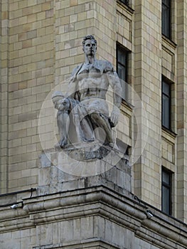 Statue of a young man on stalinist skyscraper in Kudrinskaya square.