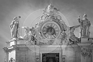 Statues and clock on the roof of the Vatican in Rome. Saint Peter