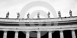 Statues on colonnades that surround St. Peter's Square in Rome photo