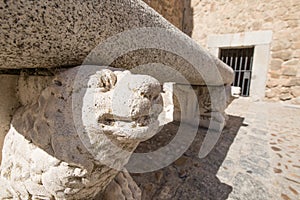 Statues of dogs holding ancient granite bench in Bisagra Gate To photo