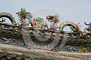 Statues of dragons decorate the roof of a temple (Vietnam)