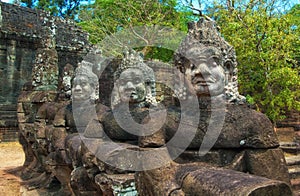 Statues in the entrance to the ancient city of Bayon in the Angkor Wat temple complex near Siem Reap, Cambodia.