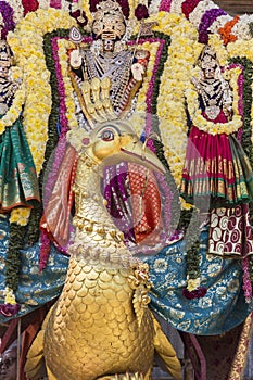 Statues of the Indian gods. Brahma, Vishnu Durga Shiva Ganesha, made with flowers for the the Masi Magam festival.