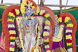 Statues of the Indian gods. Brahma, Vishnu Durga Shiva Ganesha, made with flowers for the the Masi Magam festival.