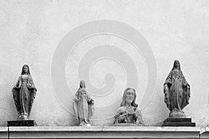 Statues of Jesus and the Virgin Mary on a wall background