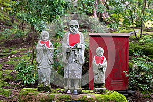 Statues of Jizo, enlightened monk who is the protector of the dead children in Japan. Jizo and water-spouting dragon