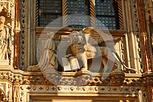 Statues of the leo or lion with wings and book and pope