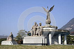 Statues next to the blue house