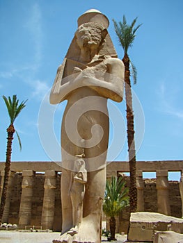 Statues of Pharaoh Ramses II and his daughter Meritamon. Ancient temple of Karnak, Luxor, Egypt.