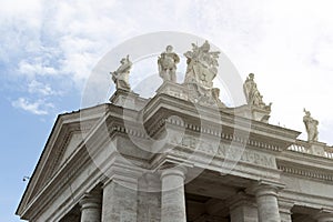 Statues of religious saints on the colonnades of St. Peter`s Basilica at St. Peter`s Square in Vatican City, Rome, Italy