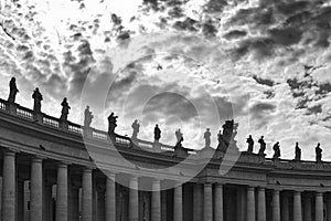 Statues of religious saints on the colonnades of St. Peter`s Basilica at St. Peter`s Square in Vatican City, Rome, Italy