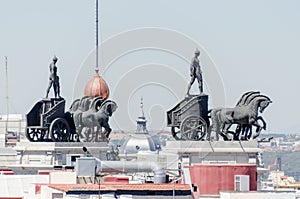 Statues on roof of Banco Bilbao Vizcaya Madrid Spain photo
