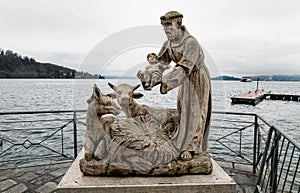 Statues of Saint Francis with Jesus child on Lake Maggiore in Laveno Mombello, Italy