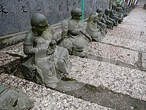 Statues on the Stairs of a Temple in Japan