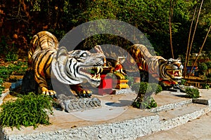 Statues of tigers at entrance to buddhist pagoda Tham Suea near Tiger Cave Temple in Krabi, Thailan