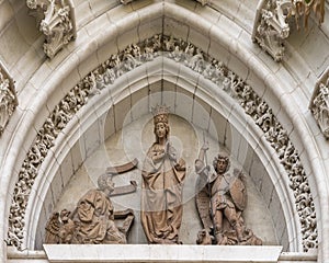 Statues in the Tympanum of the Door of Conception, opening into the Courtyard of Orange Trees in the Seville Cathedral in Spain.
