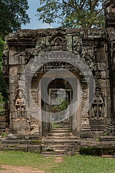 Statues in wall alcoves of temple entrance photo