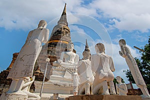 Statues of white monks praying with Buddha. at Wat Yai Chai Mongkhon a Buddhist temple in Ayutthaya, Thailand