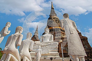 Statues of white monks praying with Buddha. at Wat Yai Chai Mongkhon a Buddhist temple in Ayutthaya, Thailand