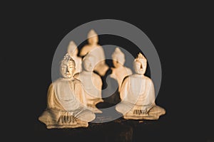 Statues of wooden budhhas meditating sitted in lotus