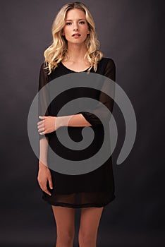 Statuesque elegance. A statuesque young blonde woman posing in studio.