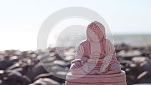 Statuette of Buddha on the beach