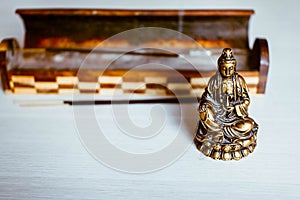 The statuette of the Buddha's blessing and incense.